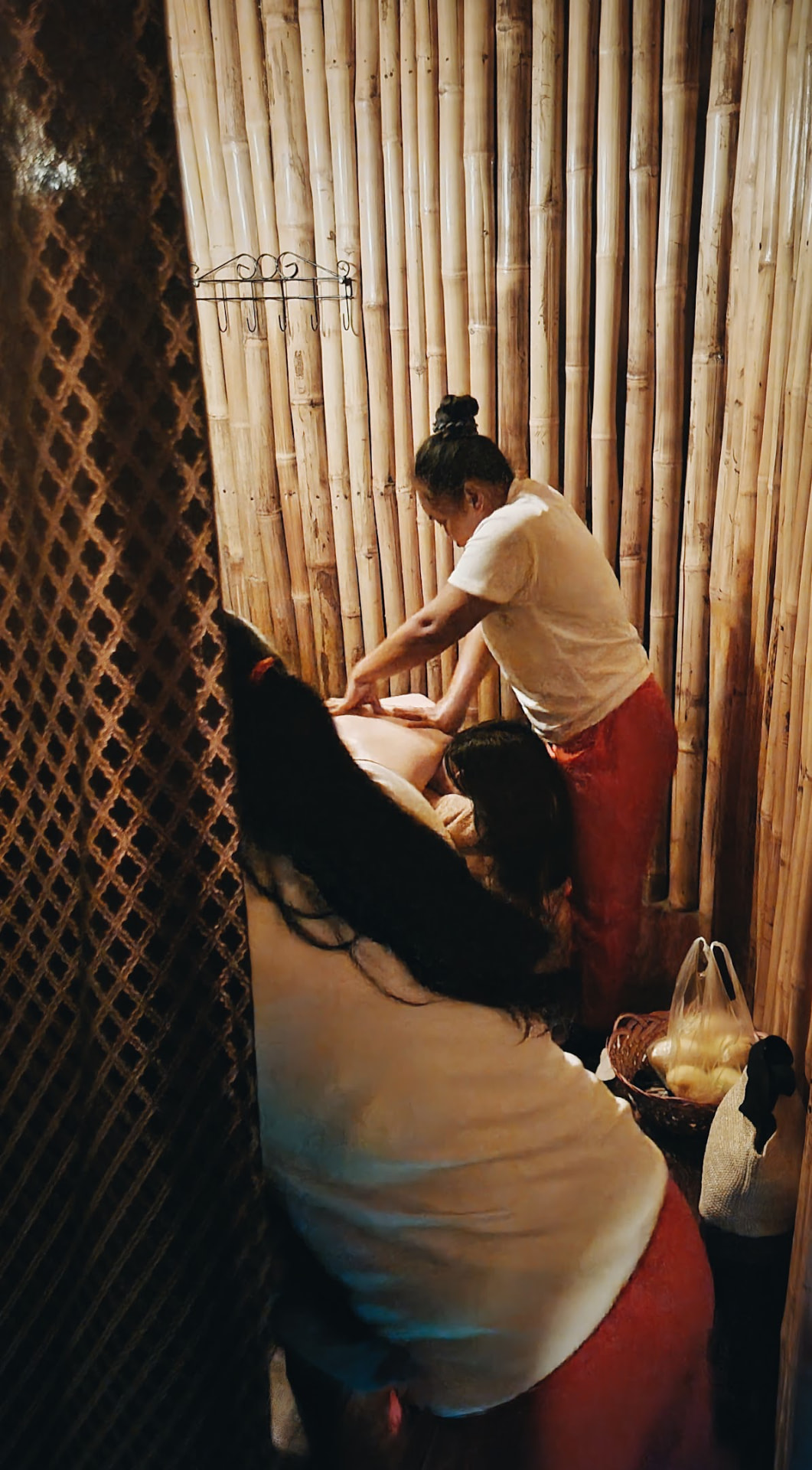 A back massage inside the bamboo cabin