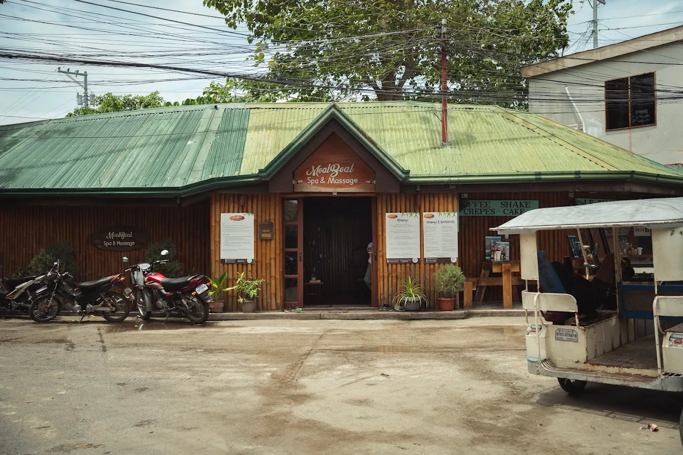 The bamboo facade of Moalboal Spa & Massage with its green roof